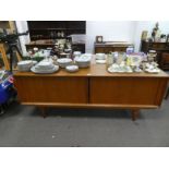 A 1960's teak sideboard having tambour sliding doors, 210cms