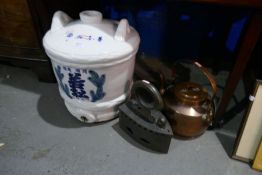 A Chinese water barrel with markings to the front and two metal items