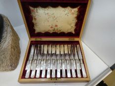 A Victorian silver plated set of twelve cake knives and forks having Mother of Pearl handles in fitt