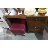 A pedestal desk having four drawers and a two tier occasional table