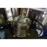 A brass coal bin having lion mask handles and an oval mahogany coffee table