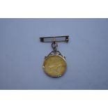 22ct Full Sovereign dated 1856, Young Victoria and Shield back, in a 9ct gold mount suspended on 9ct