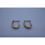 Pair of 9ct yellow gold chanel set earrings with 11 round cut diamonds marked 375, approx 1.5cm leng