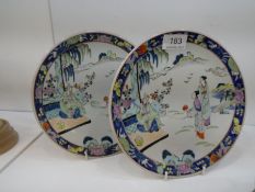 A pair of Chinese 20th Century plates decorated figures in landscape, 21.5cms