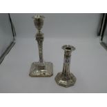 A large heavily decorated silver candlestick having embossed, ornate decoration and beaded borders.