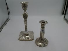 A large heavily decorated silver candlestick having embossed, ornate decoration and beaded borders.
