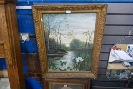 An antique oil painting of water lillies in a wooded landscape, unsigned