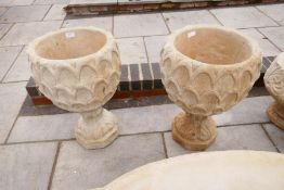 A pair of garden urns decorated pineapple