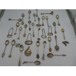 A quantity of silver and white metal items, to include spoons decanter label, souvenir spoons and en