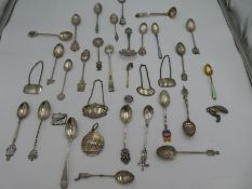 A quantity of silver and white metal items, to include spoons decanter label, souvenir spoons and en