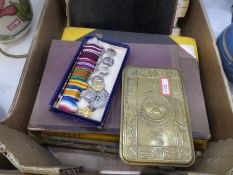 A set of seven WWI medal miniatures, a 1914 Christmas tin, related ephemera and books