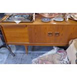 A 1970s sideboard, an extending circular table and a set of four chairs