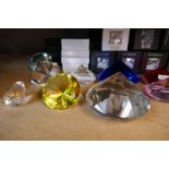 Oleg Cassini; a selection of clear and coloured glass crystal paperweights