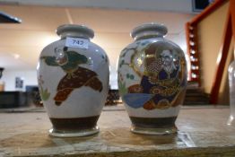 Pair of Japanese vases, decorated with figures