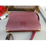 CARTIER; a red leather handbag with adjustable strap