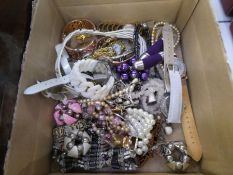 A box of mixed modern costume jewellery to include a Silver charm bracelet hung with various charms,