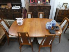A mid century Danish teak extending dining table by Mobel Fabrik having 2 leaves and a set of 6 matc
