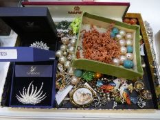 A tray of modern and vintage costume jewellery to include Swarovski brooches, hardstone beads, gilt