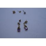 Pair of 9ct and amethyst drop earrings, single diamond stud earring, and two other yellow metal earr
