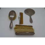 A dressing table set comprising of three silver backed brushes, a hand mirror and a comb. Hallmarked