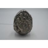 A Silver Egg, made in Greece AG995, patented. Having a religious scene embossed with a date mark