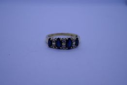 Pretty 18ct sapphire and diamond ring with 4 marquise cut sapphires separated by 3 pairs of round cu