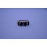 Pretty 18ct sapphire and diamond ring with 4 marquise cut sapphires separated by 3 pairs of round cu