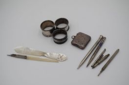 A white metal and mother of pearl quill having decorative engraved metal. With a matching pencil and