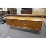 A 1970's teak sideboard having four drawers, 205cms