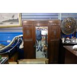 A 1930's Oak wardrobe having central mirror door with long drawer below