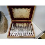 A Victorian silver plated set of twelve cake knives and forks having Mother of Pearl handles in fitt