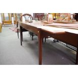 A 1970s teak sideboard by A. Younger with three central drawers and a similar extending oblong dinin