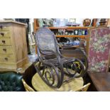 A Bentwood rocking armchair and a stool