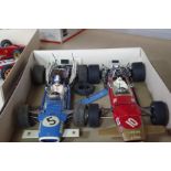 Two similar 1:12 scale 1960s Formula One cars, one being a Lotus Ford