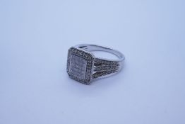 Contemporary 9ct white gold cluster ring; with rectangular panel set with 20 square cut diamonds sur