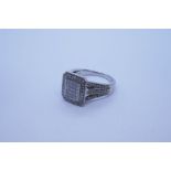 Contemporary 9ct white gold cluster ring; with rectangular panel set with 20 square cut diamonds sur