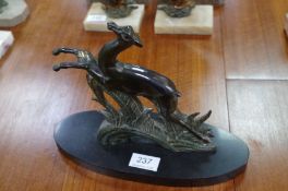 An Art Deco bronzed spelter figure of prancing deer and one other lamp with deer figure, on marble b