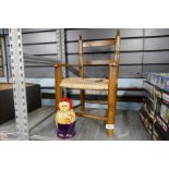 A child's reeded chair and Russian doll