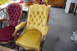 A Victorian mahogany button back armchair having scroll arms