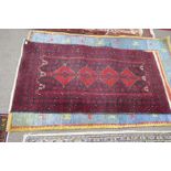 An Afghan rug having four diamond medallions and three other rugs (4)
