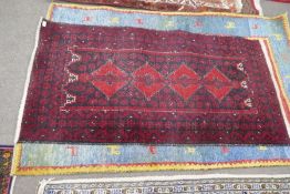 An Afghan rug having four diamond medallions and three other rugs (4)