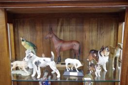 A Royal Doulton 'Lassie' dog figure HN1057, A Beswick figure of racehorse 'Arkle' a Karl Enns Parrot