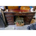 A reproduction mahogany twin pedestal desk having six drawers and cupboard