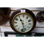 A small white dial clock similar in style to a P.O or railway clock