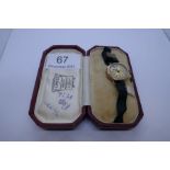 9ct gold cased ladies wristwatch with numbered dial on black fabric strap, case marked 375, CGC, in