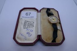 9ct gold cased ladies wristwatch with numbered dial on black fabric strap, case marked 375, CGC, in