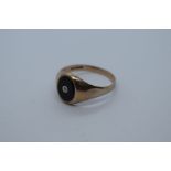 9ct yellow gold gent's signet ring with oval black panel with small central diamond chip, size 3, ma