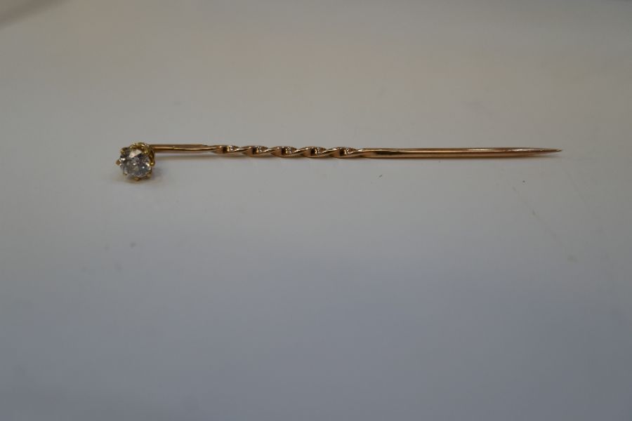Antique yellow gold stick pin with a single diamond approx 0.10 carat
