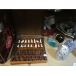 A selection of vintage glass paperweights, small chess set etc