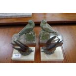 Two pairs of French Art Deco bookends of swallows on marble and alabaster ases